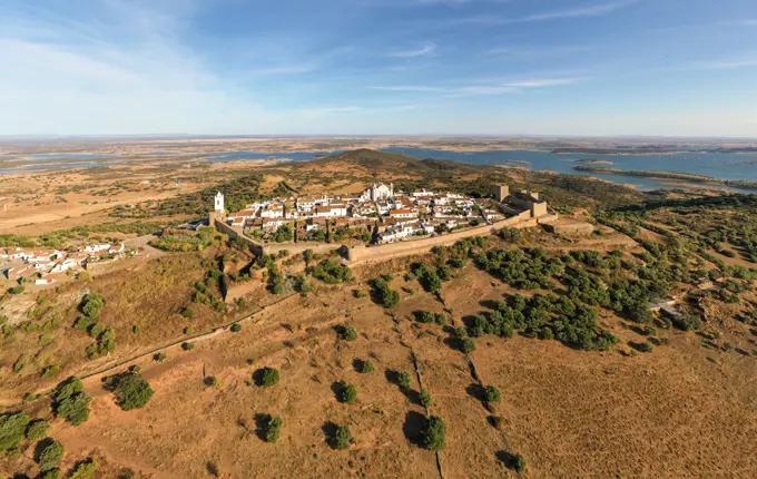 Aerial view of the Monsaraz Castle on a hill overlooking countryside, Portugal.