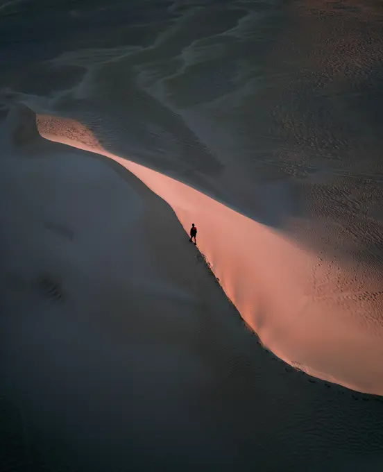 Aerial view of someone exploring during sunrise on the Lancelin Sand Dunes, Western Australia