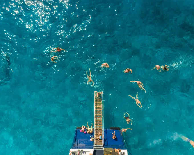 ITHAKI - GREECE, AUGUST 9 2018: Aerial view of people on ferry and swimming in sea, Ithaki island, Greece.