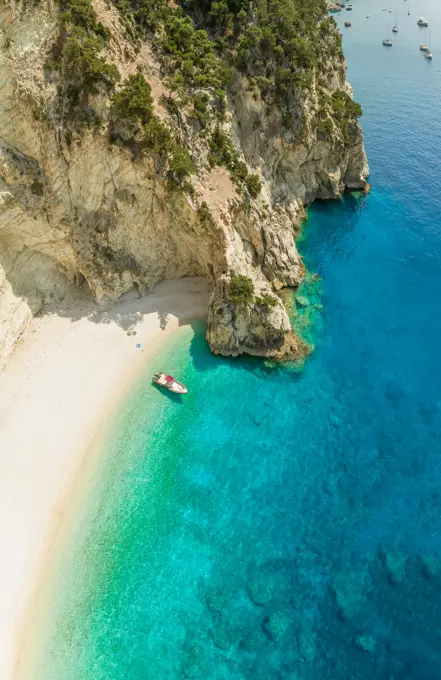 Aerial view of boat anchored on beach in Sivota, Greece.