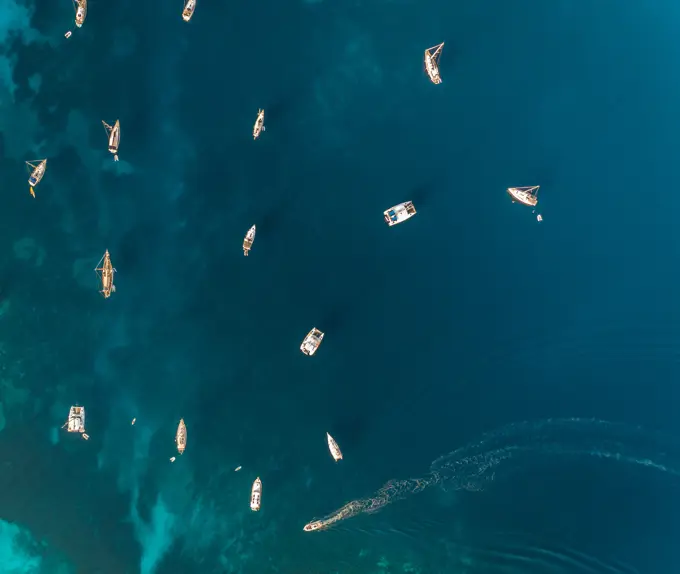 Aerial view of group of boats anchored in the mediterranean sea, Kastos island, Greece.