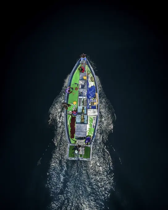 Aerial view of a traditional fishing boat cruising through the ocean in Kaafu atoll, Maldives.