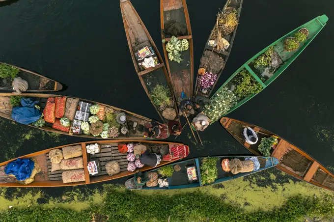 Aerial view of People on typical boats along the river during the floating market, Rainawari, Srinagar, Jammu and Kashmir, India.