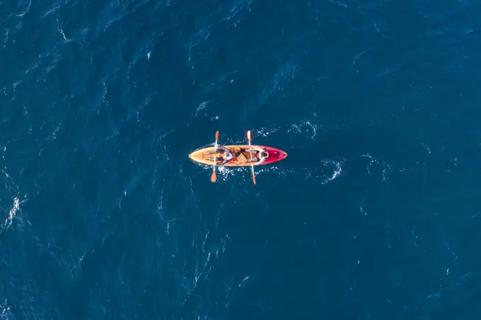 Azores, Portugal - 13 May 2021: Aerial view of two persons doing kayak in the ocean near San Miguel island, Azores islands, Portugal.