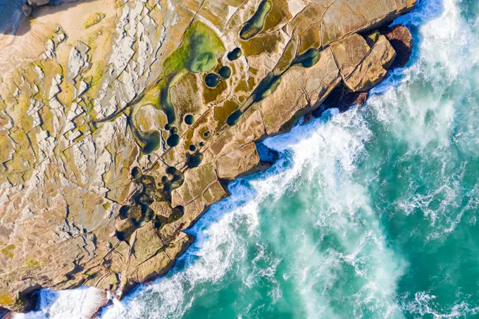 Aerial view above dangerous rock shelf in Sydney's Royal National Park, Australia.