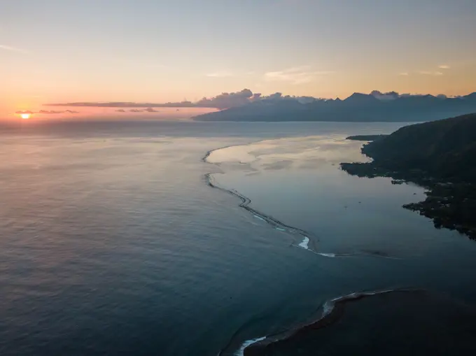 Aerial view of Tahiti coastline at sunset in French Polynesia.