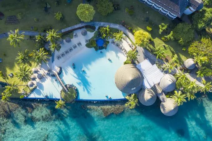 Aerial view of a swimming pool with garden of a luxury resort and hotel in Tahiti, French Polynesia.