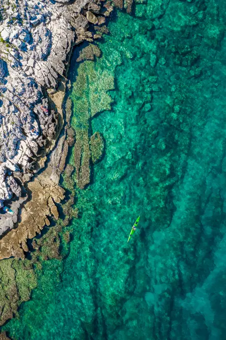 Aerial view of a kayak in the turquoise waters of Bale, Croatia