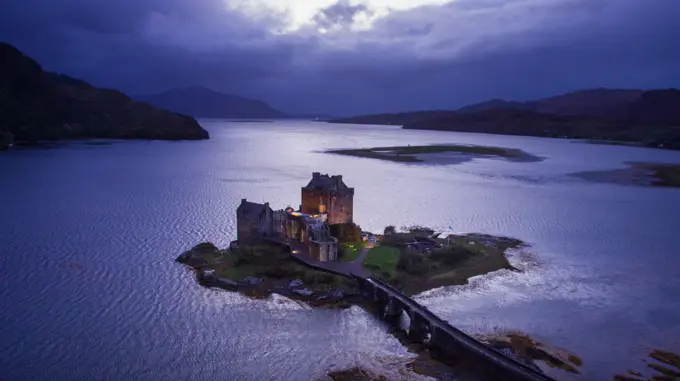 Aerial view of dusk at famous Aielan Donan castle near Dornie in Scotland.