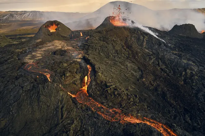 Aerial view of lava streaming down the mountain ridge, view of a river of lava flowing from the craters in Grindavík, Southern Peninsula, Iceland.