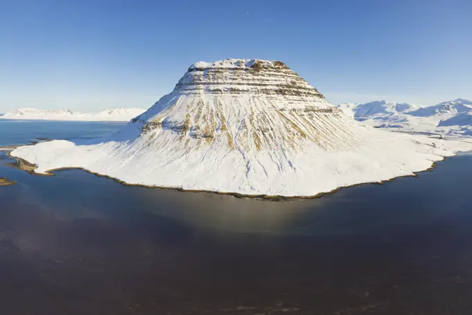 Aerial view of Kirkjufell mountain in winter covered with snow, Snaefellsnes, Iceland.