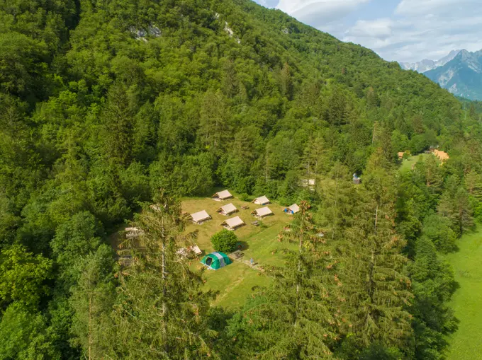 Aerial view of camping houses in the middle of the forest in the Soca valley, near Bovec, Slovenia.