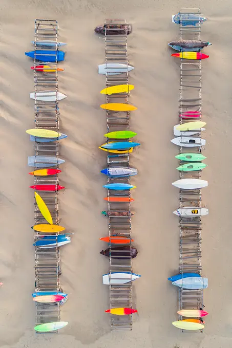 Aerial view of kayaks over the clear sand beach.