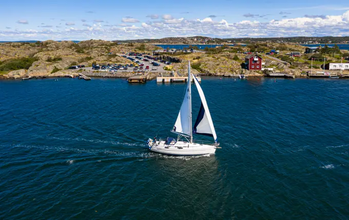 Aerial view of sailing boats cruising at the coast of Björkö island, Kattegat, Gothenburg archipelago, Sweden.