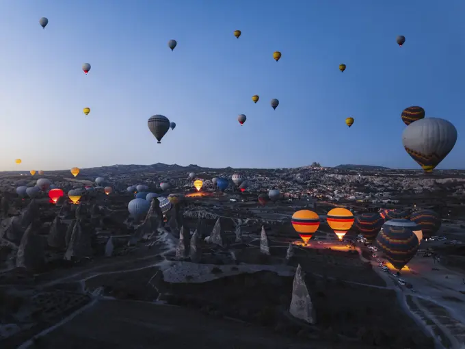 Aerial view of hot air balloons at sunrise in Cappadocia, Turkey.