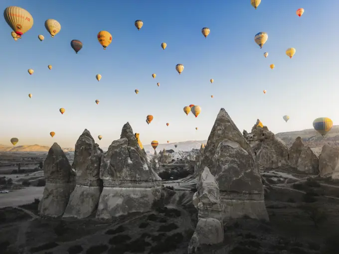 Cappadocia, Turkey - 23 October 2022: Aerial view of hot air balloons at sunrise.