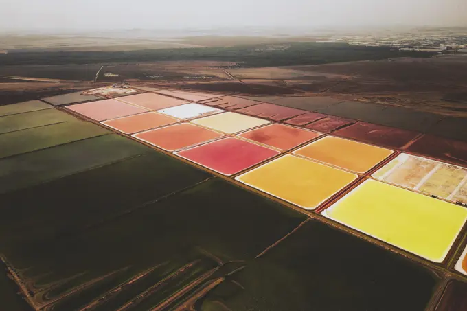 Aerial view of colourful Salinas, salt lakes pool at Farm colony la Algaida, Andalusia, Spain.