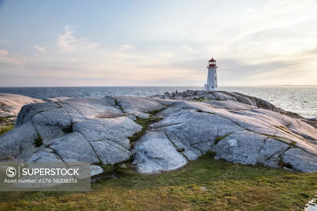 A rocky outcrop and a landmark lighthouse in Peggy's Cove, Nova Scotia, Canada