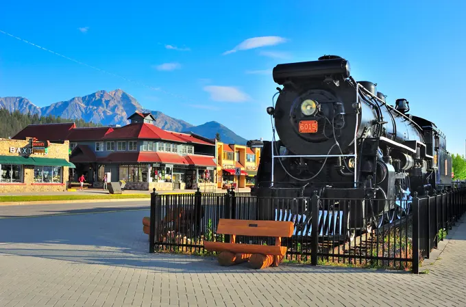 An antique locomotive steam engine used as a tourist attraction in the town of Jasper in Jasper National Park, Alberta,Canada, on a clear summer day