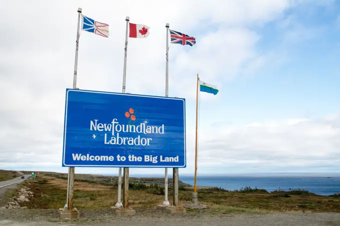 Welcome sign at the Newfoundland Labrador border crossing with Quebec, and the Strait of Belle Isle on the Atlantic coast, near Blanc Sablon, Canada.