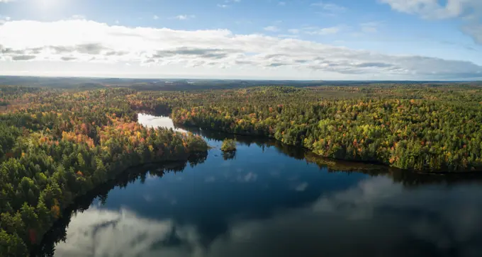 Aerial panoramic view of a beautiful lake during a sunny autumn day. Taken in Charlotte Lake, Queens, Caledonia, Nova Scotia, Canada.