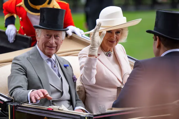 The King and Queen attended the final Day of Royal Ascot 2024 on Saturday. The King looked in good spirits as he and the Queen attended the closing day of Royal Ascot 2024. This was the fourth day out of five  that the King attended the Queen attended all five days. The King wore a grey suit with a grey waistcoat and a black top hat. The Queen wore a light pink coat dress embossed with white lace.