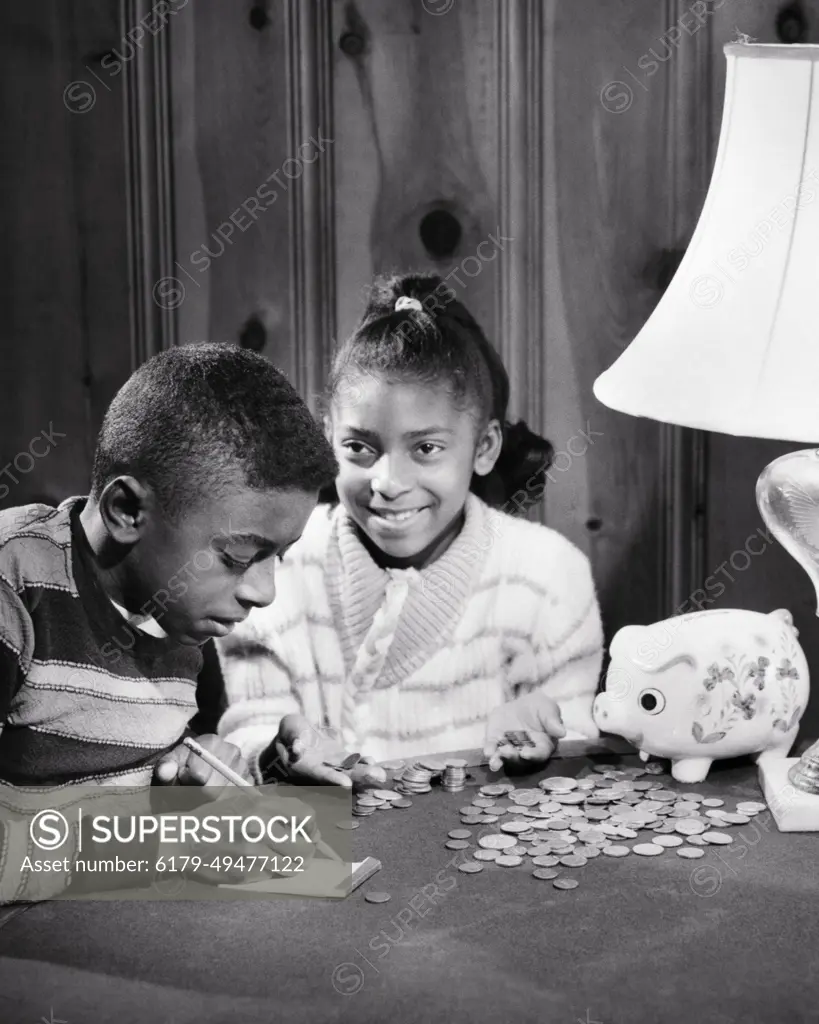 1960s FRUGAL SMILING AFRICAN-AMERICAN BOY GIRL BROTHER SISTER COUNTING  MONEY FROM THEIR PIGGY BANK - SuperStock