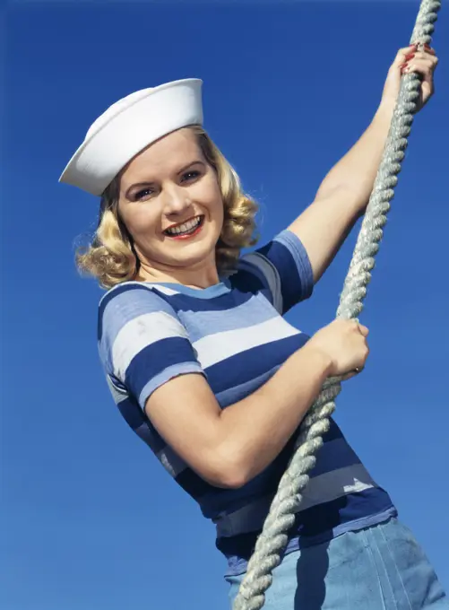 1940S Smiling Blond Girl Wearing Navy Sailor Hat Blue Striped Shirt And Pulling On Nautical Rope