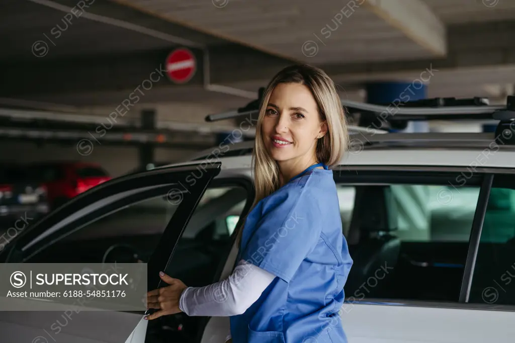 Nurse getting into car, going home from work. Female doctor driving car to work, on-call duty. Work-life balance of healthcare worker. Female nurse getting into car, going home from work. Female doctor driving car to work, on-call duty. Work-life balance of healthcare staff. model released