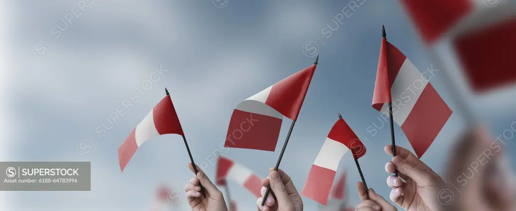 A group of people holding small flags of the Peru in their hands A group of people holding small flags of the Peru in their hands. Copyright: xZoonar.com/AlekseyxButenkovx 20098182