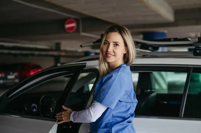 Nurse getting into car, going home from work. Female doctor driving car to work, on-call duty. Work-life balance of healthcare worker. Female nurse getting into car, going home from work. Female doctor driving car to work, on-call duty. Work-life balance of healthcare staff. model released