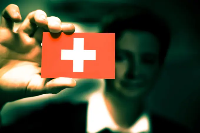 Businessman is holding a business card, flag of Switzerland Businessman is holding a business card, flag of Switzerland Copyright: xZoonar.com/YogeshxMorex 5517875