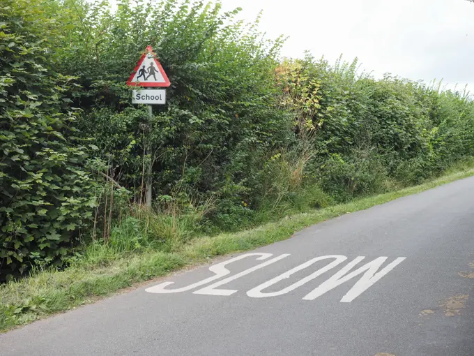 Slow sign Slow sign painted on tarmac on a british road near a school Copyright: xZoonar.com/ClaudioxDiviziax 7886862