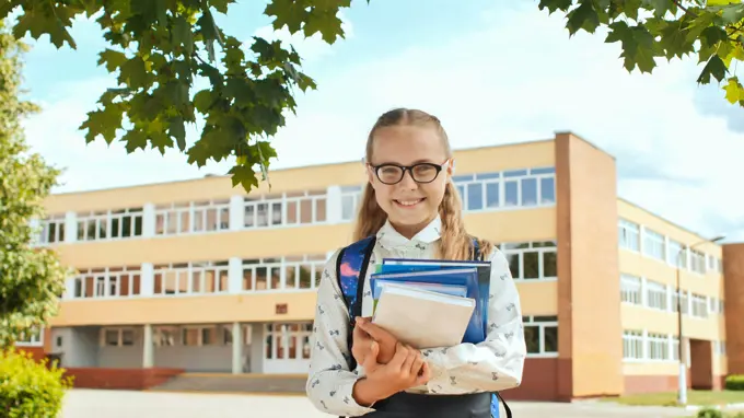 Portrait of smiling school girl child with backpack and books. Portrait of smiling school girl child with backpack and book ,model released, Symbolfoto Copyright: xZoonar.com/MikhailxDavidovichx 14346113 ,model released, Symbolfoto ,property released