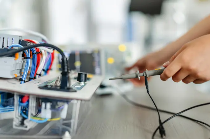 Working on circuit board, building robot in after-school robotics club. Children learning robotics in Elementary school. Working on circuit board, building robot in an after-school robotics club. Children learning robotics in Elementary school. model released