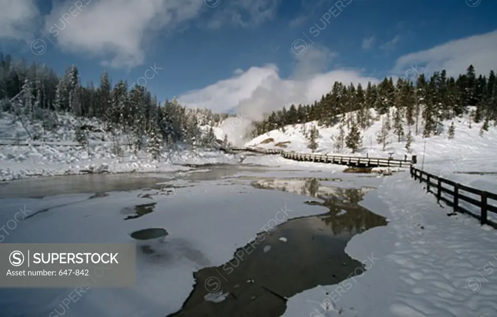 Fence along a frozen lake, Yellowstone National Park, Wyoming, USA