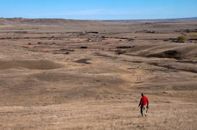 Man hiking in a desert, Grasslands National Park, Saskatchewan, Canada