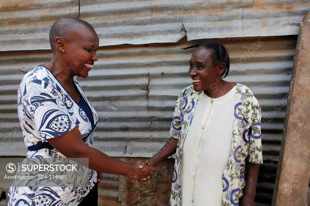 WOFAK Women Fighting Aids in Kenya worker visiting a woman who supports her grandchildren as her children died of AIDS.