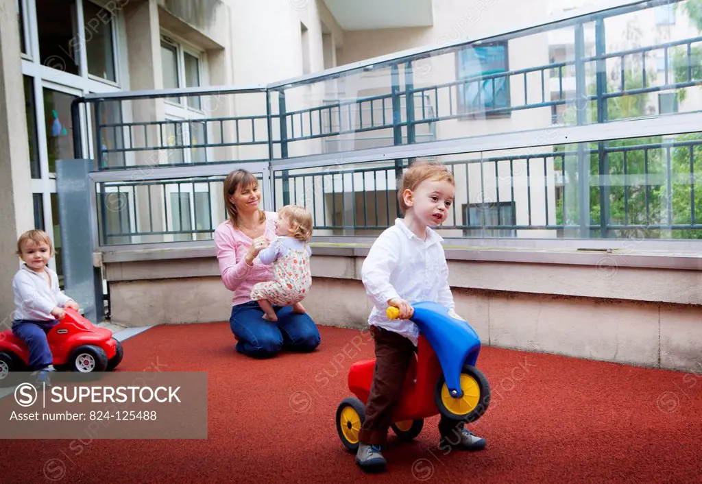 Reportage in a community nursery in Paris, France. Childcare assistant. The images from this series must only be used to illustrate articles about nur...