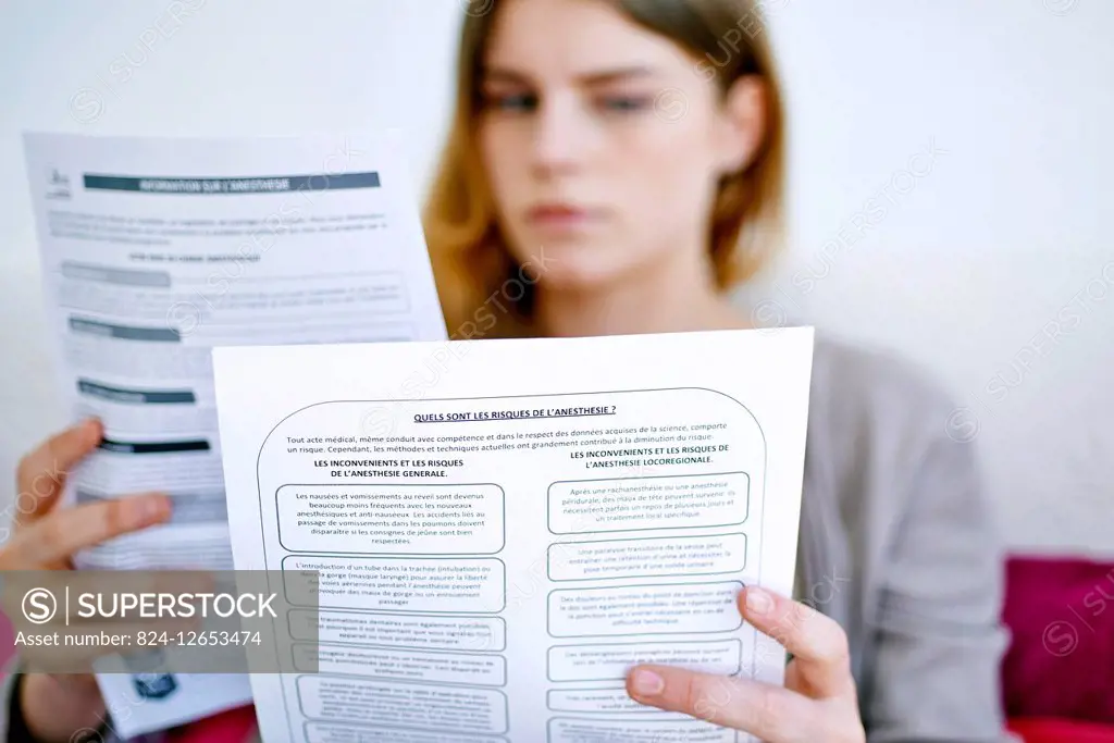 Woman reading a document with medical information on anesthesia.