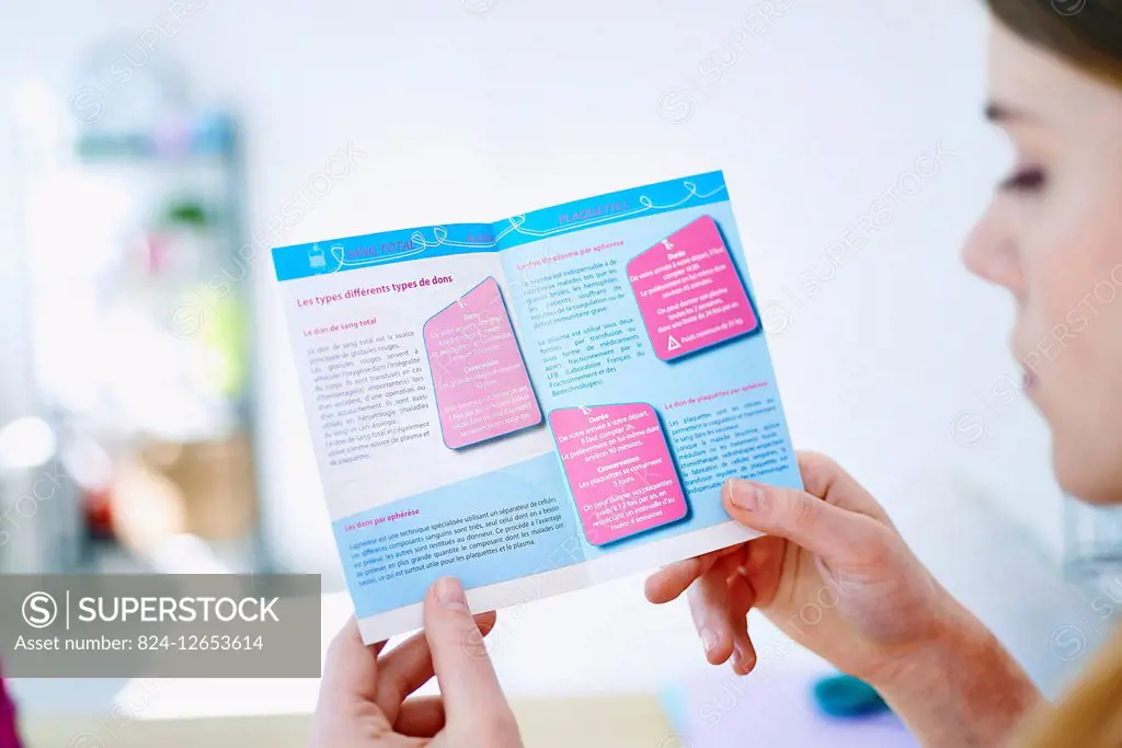 Woman reading a pamphlet on blood donation.