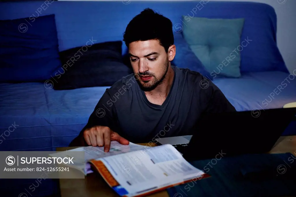 Young man studying at night.