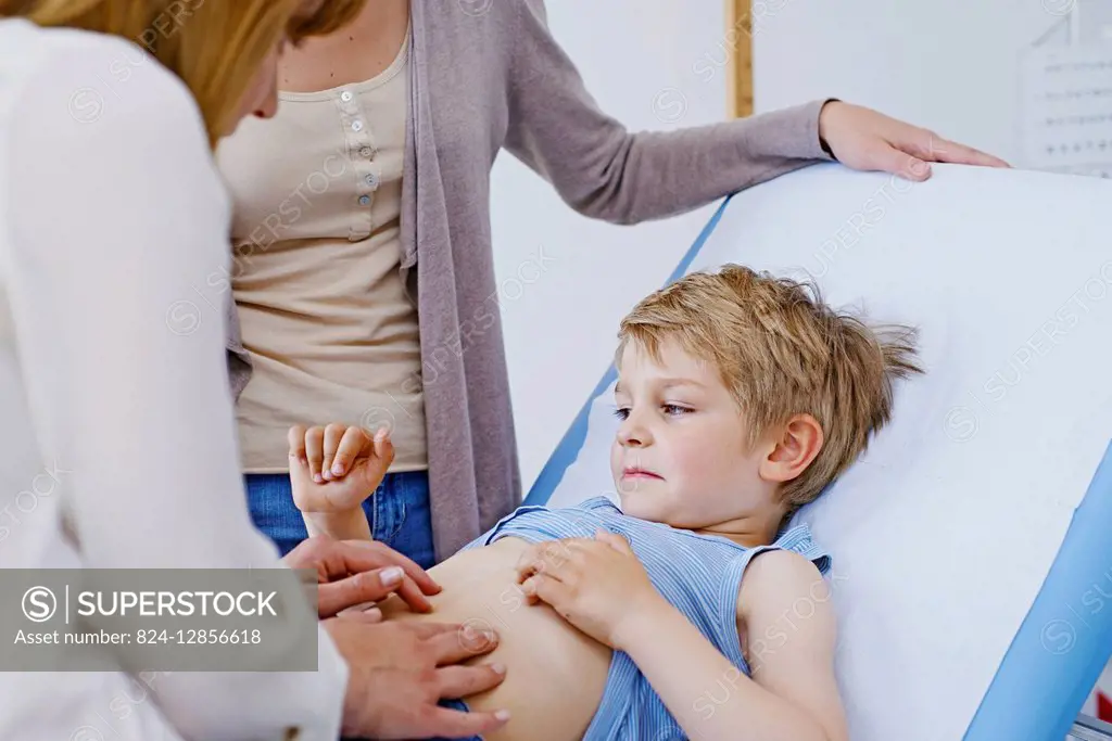 Doctor examining a child's abdomen.