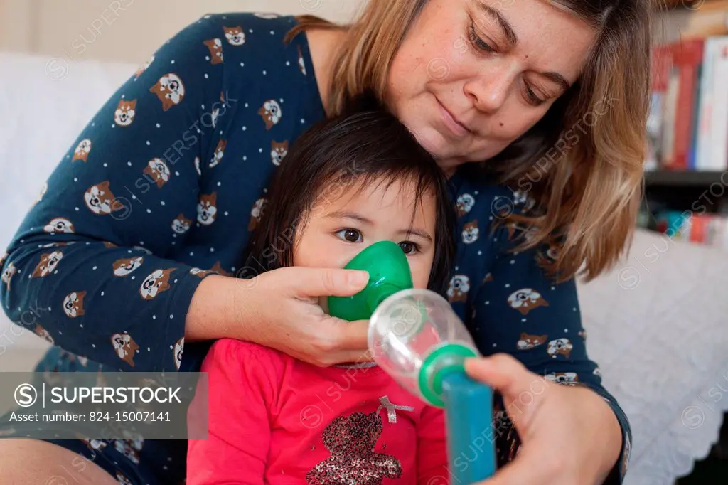 17-month old baby using an inhaler.