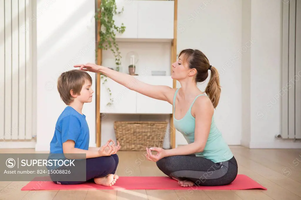 Mother and son practicing meditation.