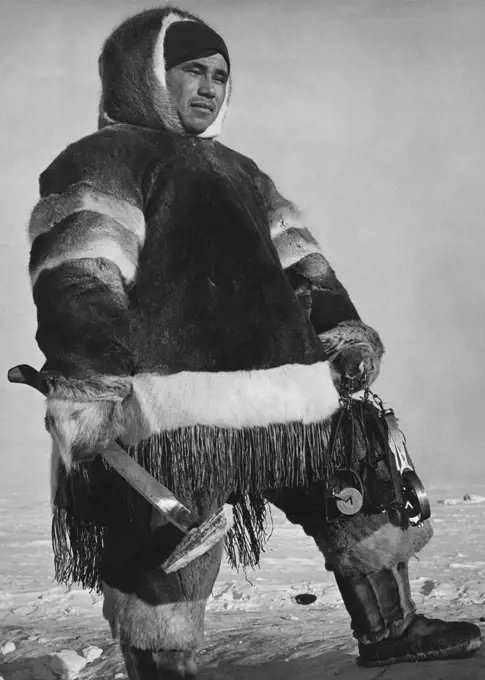 Eskimo man holding an axe, Northwest Territories, Canada